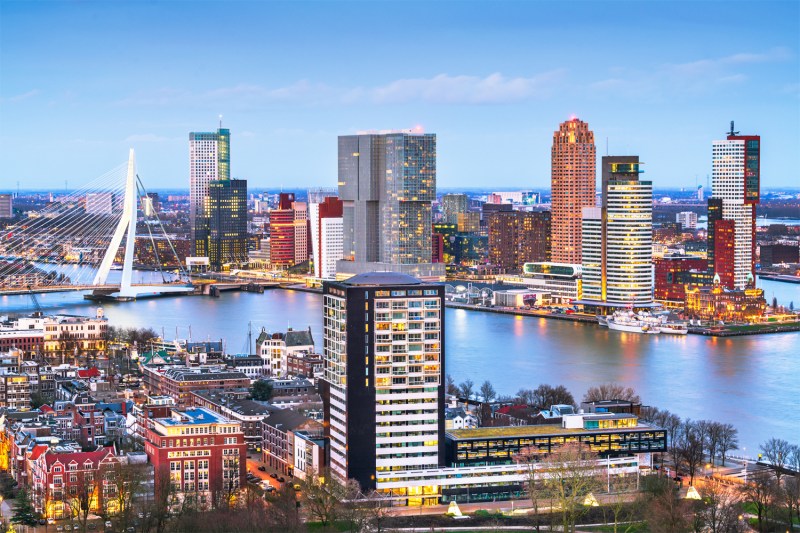 Rotterdam skyline along the Nieuwe Maas, featuring the Erasmus Bridge and the high-rise buildings of Kop van Zuid.